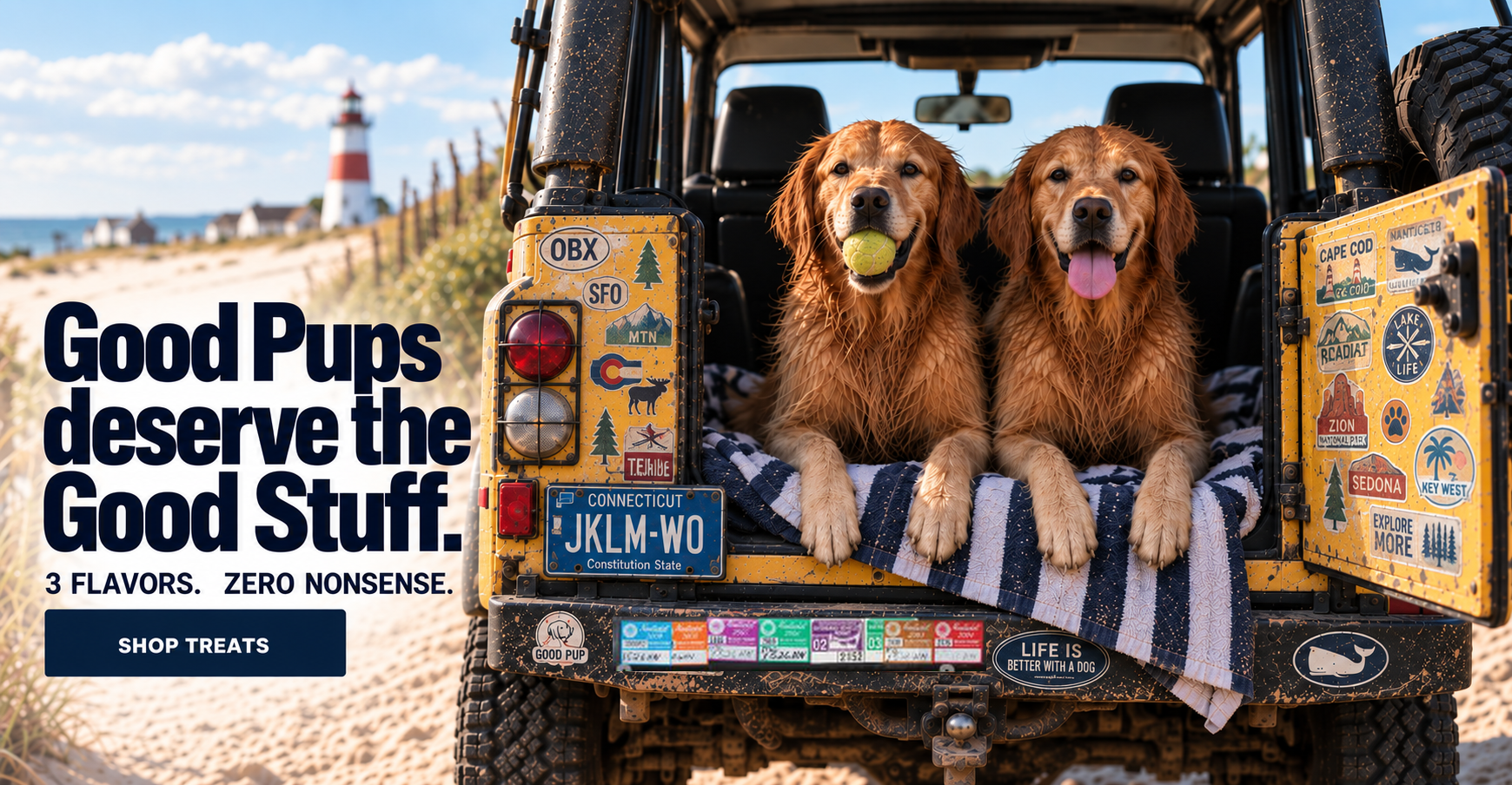 Two wet golden retrievers in the back of a yellow Defender by the beach